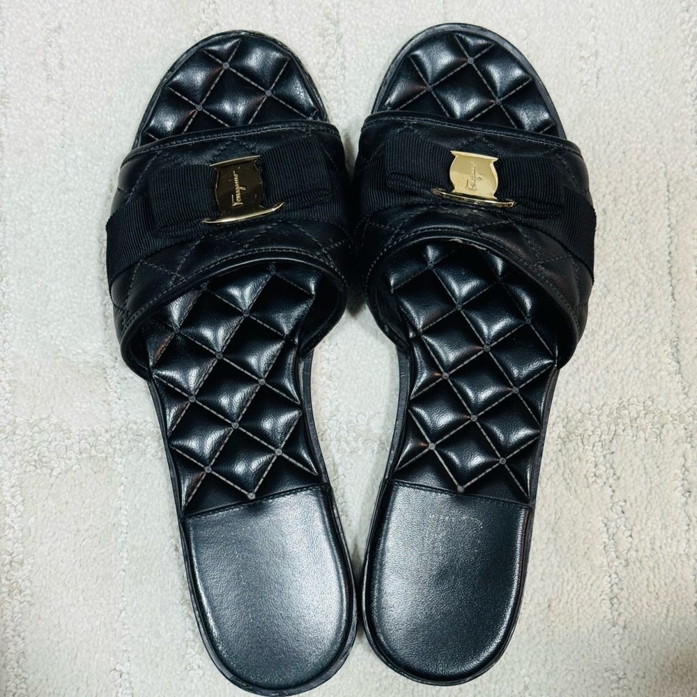 Salvatore Ferragamo Black Leather Quilted Slide Sandals with Logo Bow Accent.
